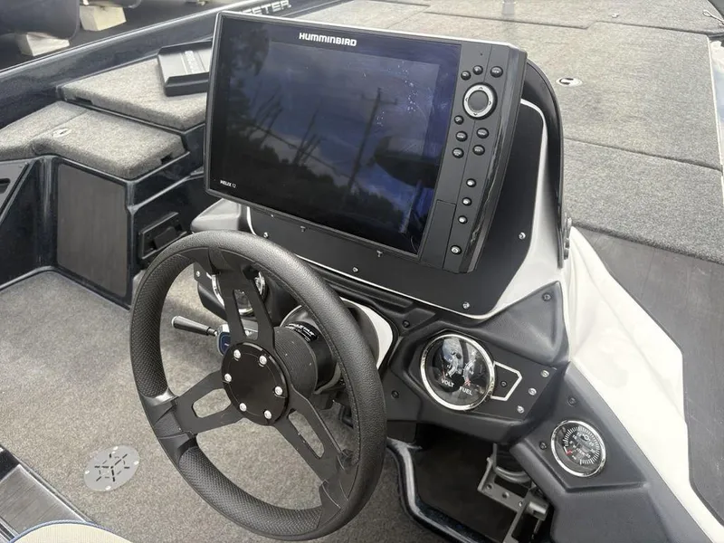 Slide: The Image of 2023 Skeeter ZXR 20 boat dashboard with steering wheel and Humminbird Helix 12 fishfinder. - 16