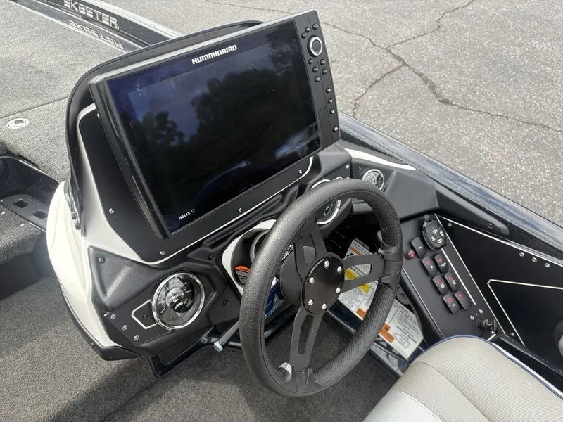 Slide: The Image of 2023 Skeeter ZXR 20 boat dashboard with steering wheel and Humminbird Helix 12 display. - 18