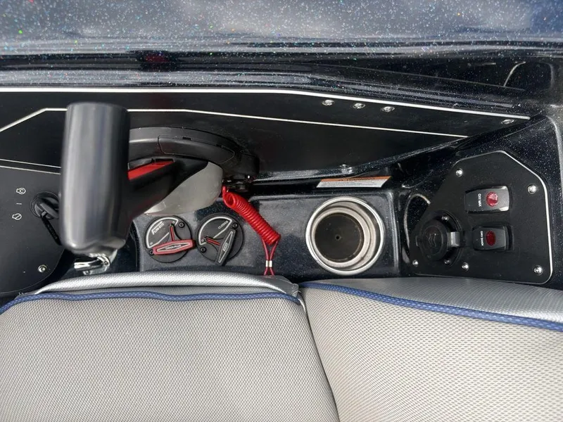 Slide: The Image of 2023 Skeeter ZXR 20 boat console with controls, cup holder, and switches. - 19
