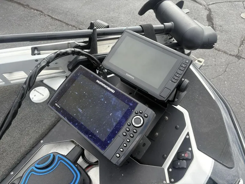 Slide: The Image of 2023 Skeeter ZXR 20 boat foot pedal and controls on carpeted deck. - 2