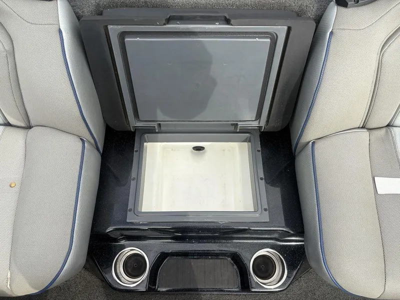 Slide: The Image of 2023 Skeeter ZXR 20 boat interior with open storage compartment and cup holders. - 22