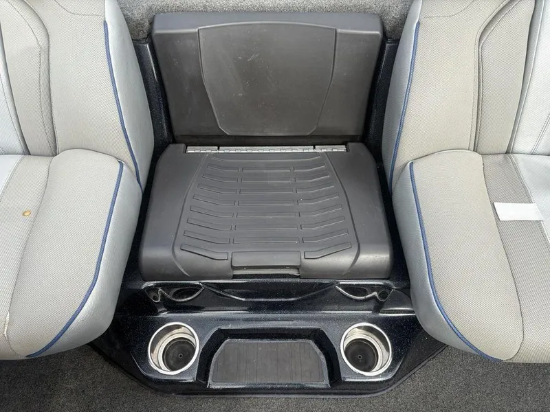 Slide: The Image of 2023 Skeeter ZXR 20 boat seating area with cup holders and storage compartment. - 23
