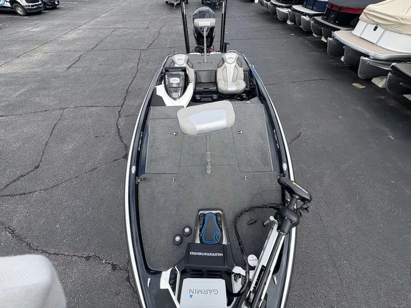 Slide: The Image of 2023 Skeeter ZXR 20 fishing boat with advanced navigation equipment, parked in a marina. - 24