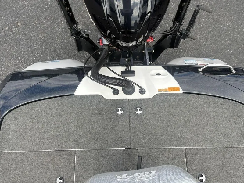 Slide: The Image of 2023 Skeeter ZXR 20 boat deck with motor and carpeted surface. - 25