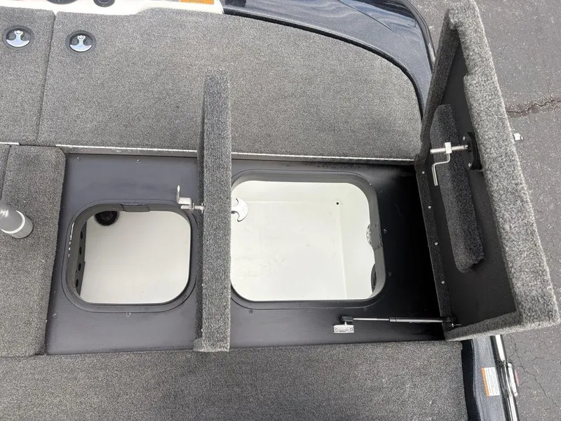 Slide: The Image of 2023 Skeeter ZXR 20 boat storage compartments with open hatches, showcasing interior space. - 26