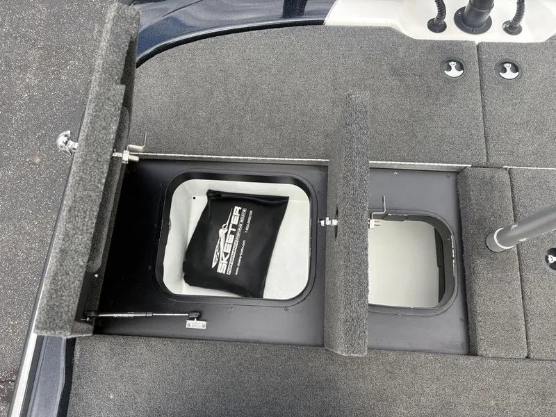 Slide: The Image of 2023 Skeeter ZXR 20 boat storage compartments with open hatches and visible interior. - 30