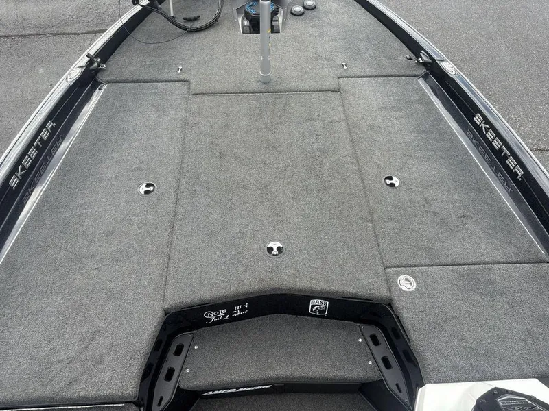 Slide: The Image of 2023 Skeeter ZXR 20 boat deck with gray carpet and storage compartments. - 6
