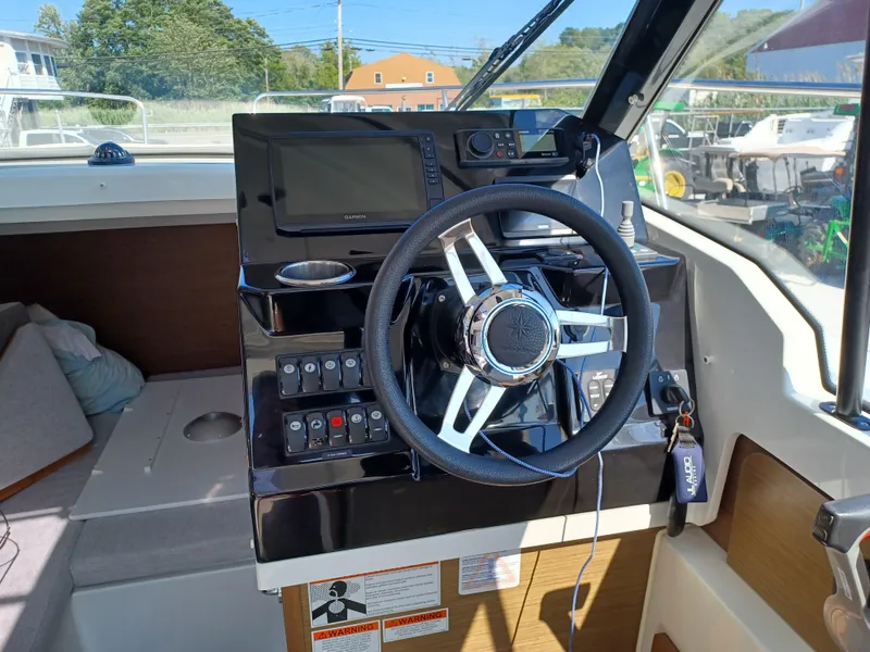 Slide: The Image of Steering console of 2022 Jeanneau NC Weekender 795 Series 2 boat with navigation equipment. - 10