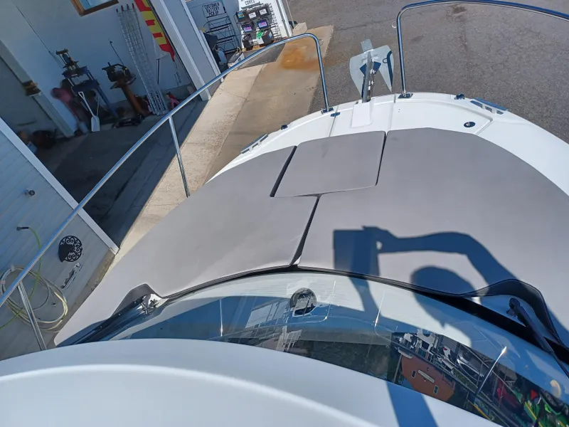 Slide: The Image of 2022 Jeanneau NC Weekender 795 Series 2 boat deck with sunpad and dock view. - 12