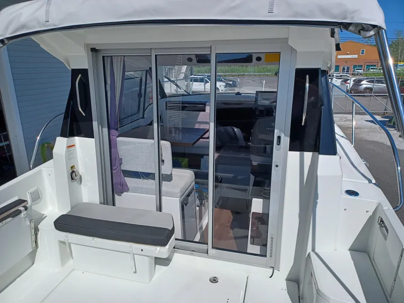 Slide: The Image of 2022 Jeanneau NC Weekender 795 Series 2 boat with sliding glass doors and seating area. - 14
