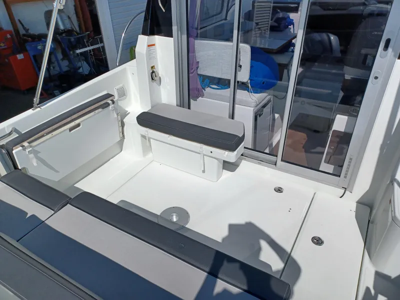 Slide: The Image of 2022 Jeanneau NC Weekender 795 Series 2 boat interior with seating and sliding glass doors. - 4