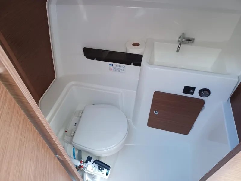 Slide: The Image of Compact bathroom in 2022 Jeanneau NC Weekender 795 Series 2 boat, featuring toilet and sink. - 7