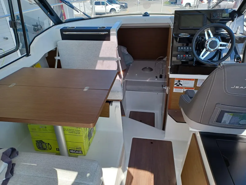Slide: The Image of Interior of 2022 Jeanneau NC Weekender 795 Series 2, featuring helm and seating area. - 8