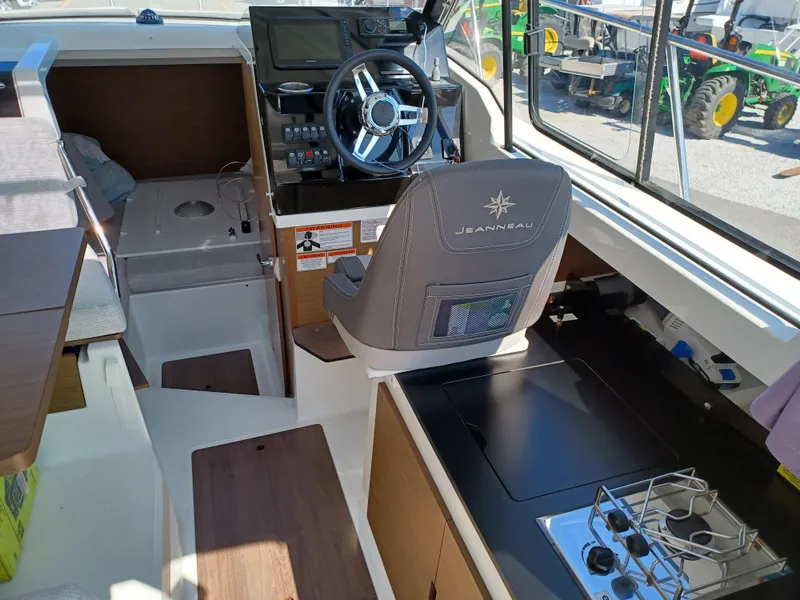 Slide: The Image of Interior of 2022 Jeanneau NC Weekender 795 Series 2 boat with helm and kitchenette. - 9