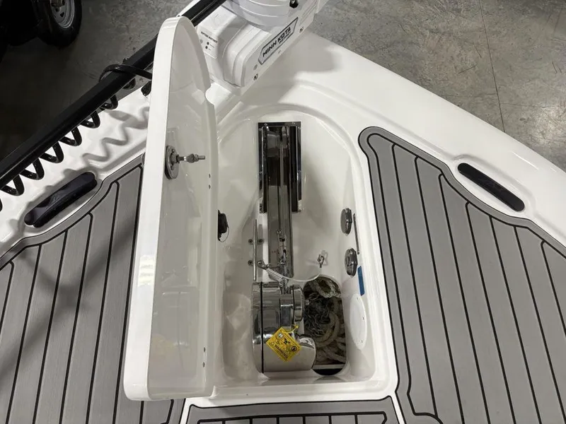 Slide: The Image of 2026 Tidewater 2700 CB boat anchor compartment with open hatch and visible winch system. - 10