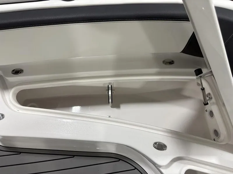 Slide: The Image of Open storage compartment on 2026 Tidewater 2700 CB boat, featuring sleek white interior design. - 16