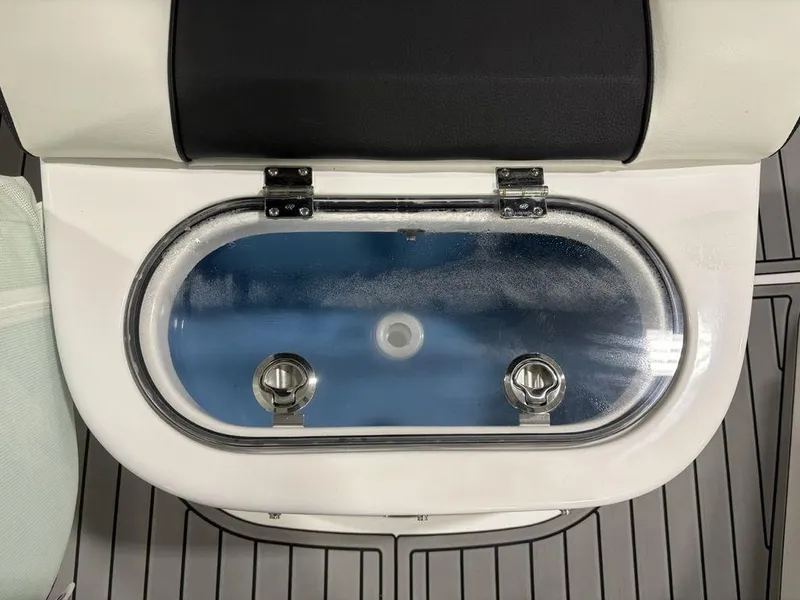Slide: The Image of 2026 Tidewater 2700 CB boat livewell with transparent lid and secure latches. - 18