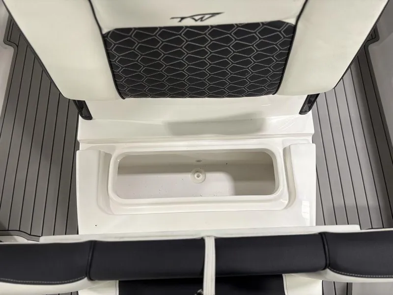 Slide: The Image of 2026 Tidewater 2700 CB boat interior with storage compartment and cushioned seating. - 21