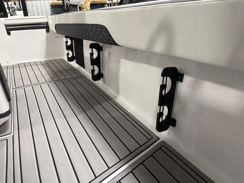 Slide: The Image of 2026 Tidewater 2700 CB boat interior with sleek flooring and rod holders. - 22