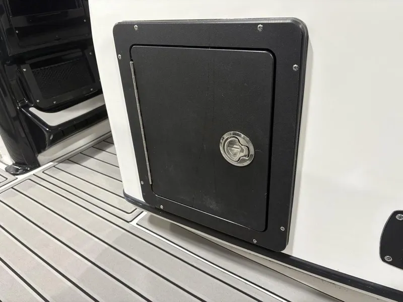 Slide: The Image of Storage compartment on 2026 Tidewater 2700 CB boat with sleek design and secure latch. - 29