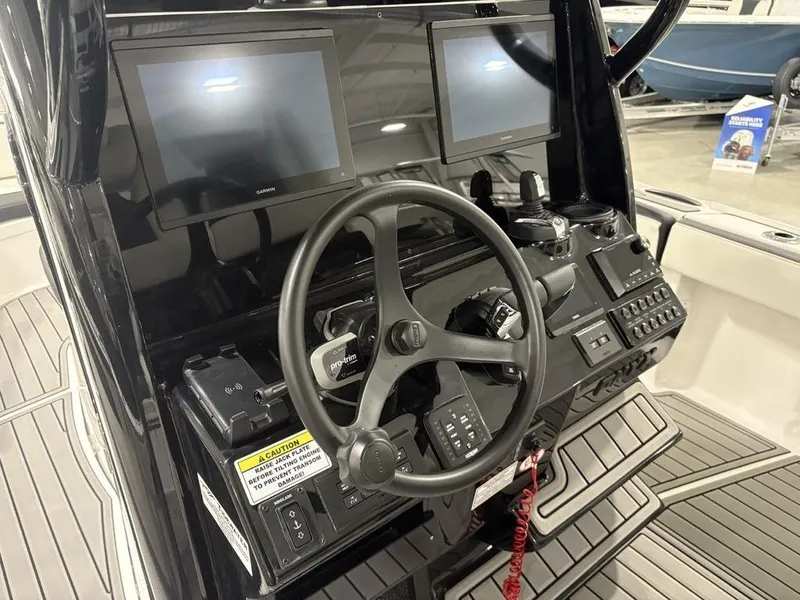 Slide: The Image of 2026 Tidewater 2700 CB boat dashboard with dual screens and steering wheel. - 30