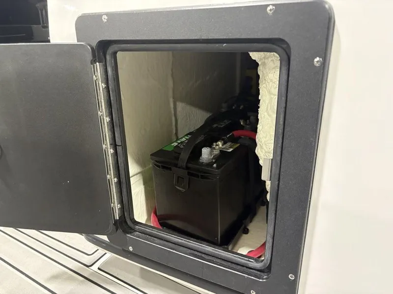 Slide: The Image of Battery compartment of 2026 Tidewater 2700 CB boat, showing installed battery. - 31