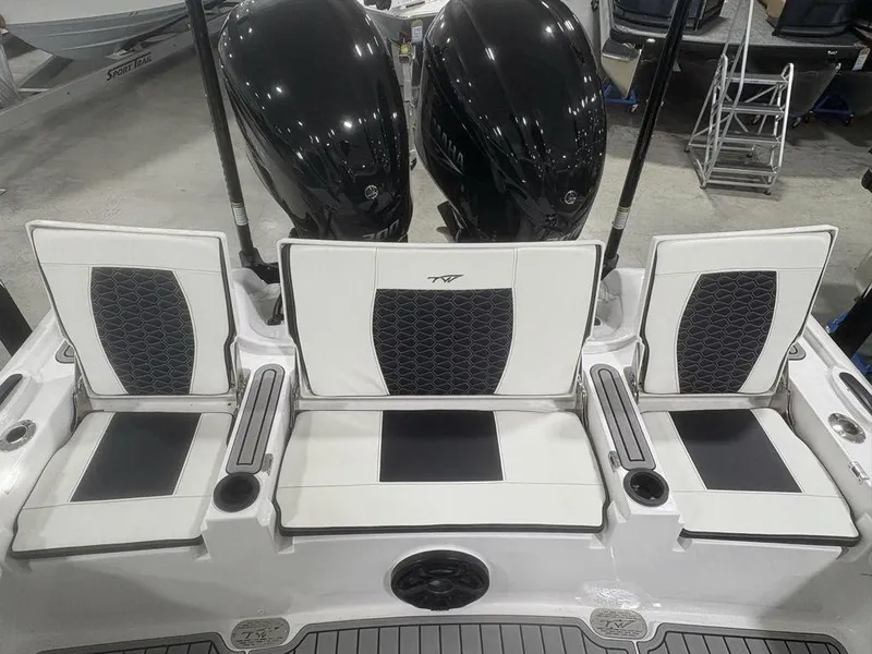 Slide: The Image of 2026 Tidewater 2700 CB boat seats with dual outboard motors in showroom. - 38