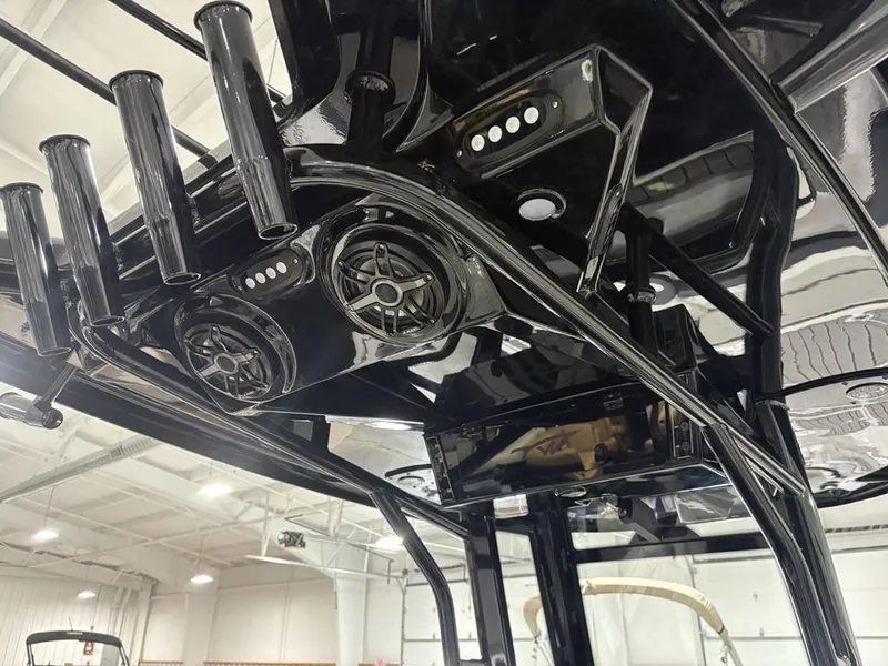 Slide: The Image of 2026 Tidewater 2700 CB boat interior with black rod holders and speakers. - 39