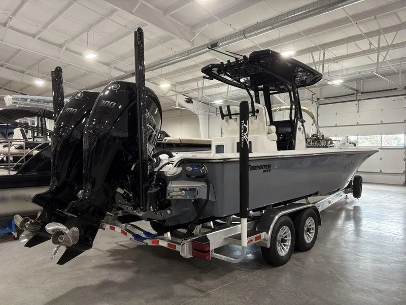 Slide: The Image of 2026 Tidewater 2700 CB boat with dual engines on a trailer in a showroom. - 4