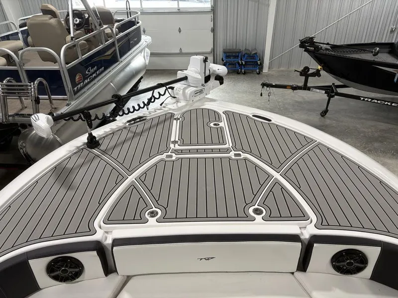 Slide: The Image of 2026 Tidewater 2700 CB boat deck with gray non-slip surface in a showroom. - 5