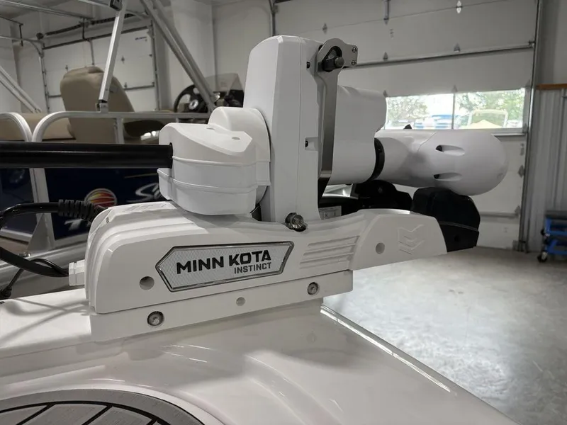 Slide: The Image of Minn Kota Instinct motor on 2026 Tidewater 2700 CB boat in garage. - 8
