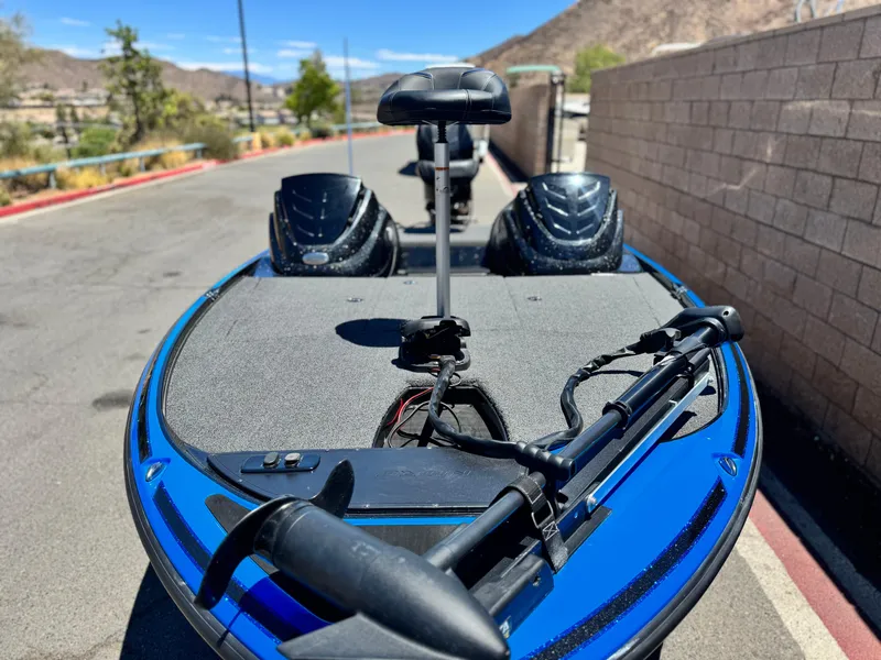Slide: The Image of 2024 Tracker Z17 boat with blue deck, parked on a sunny day. - 10