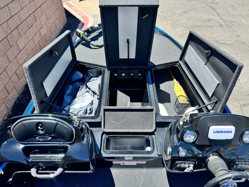 Slide: The Image of 2024 Tracker Z17 boat interior with storage compartments and Lowrance electronics. - 12