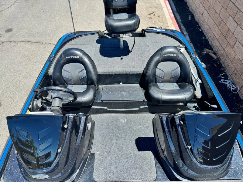 Slide: The Image of 2024 Tracker Z17 boat interior with black seats and steering wheel. - 13