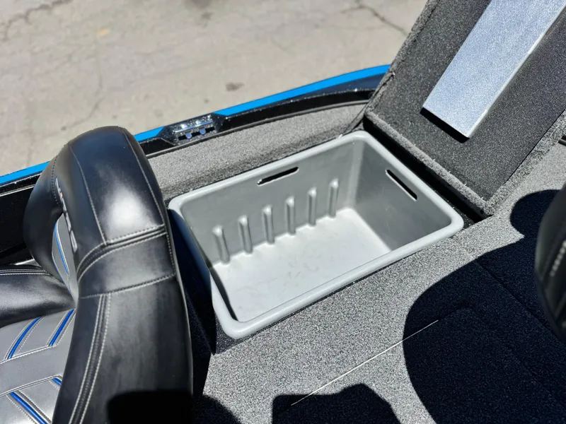 Slide: The Image of 2024 Tracker Z17 boat interior with open storage compartment and black seat. - 16