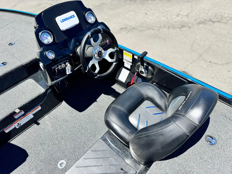 Slide: The Image of 2024 Tracker Z17 boat cockpit with steering wheel and seat, featuring Lowrance electronics. - 18