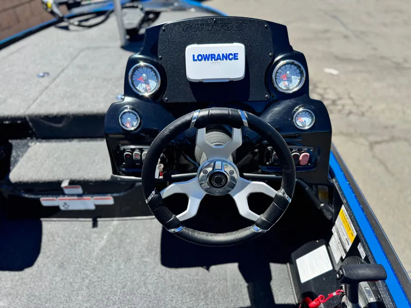 Slide: The Image of 2024 Tracker Z17 boat dashboard with steering wheel and Lowrance display. - 19