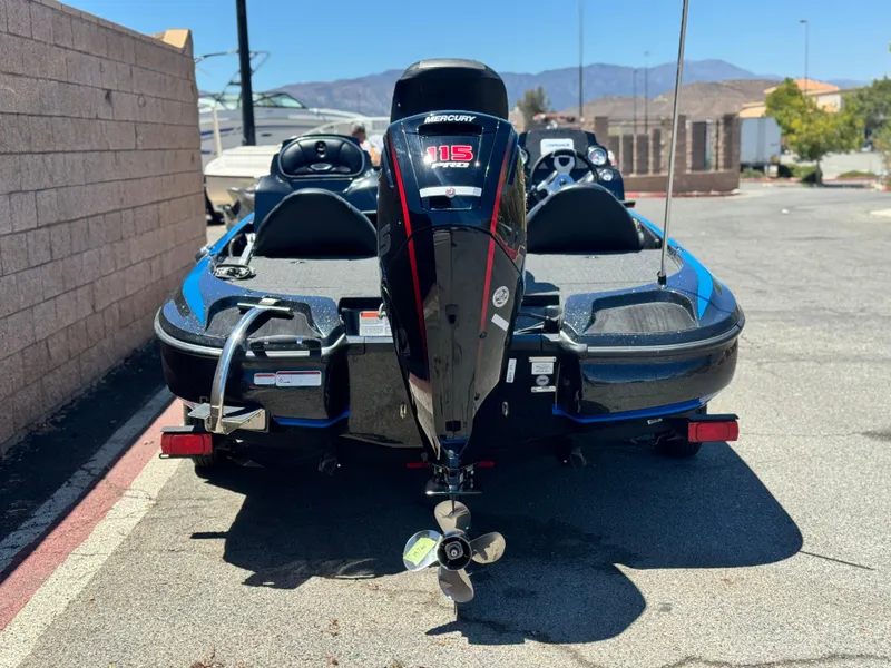 Slide: The Image of 2024 Tracker Z17 boat with Mercury 115 engine, parked outdoors. - 4