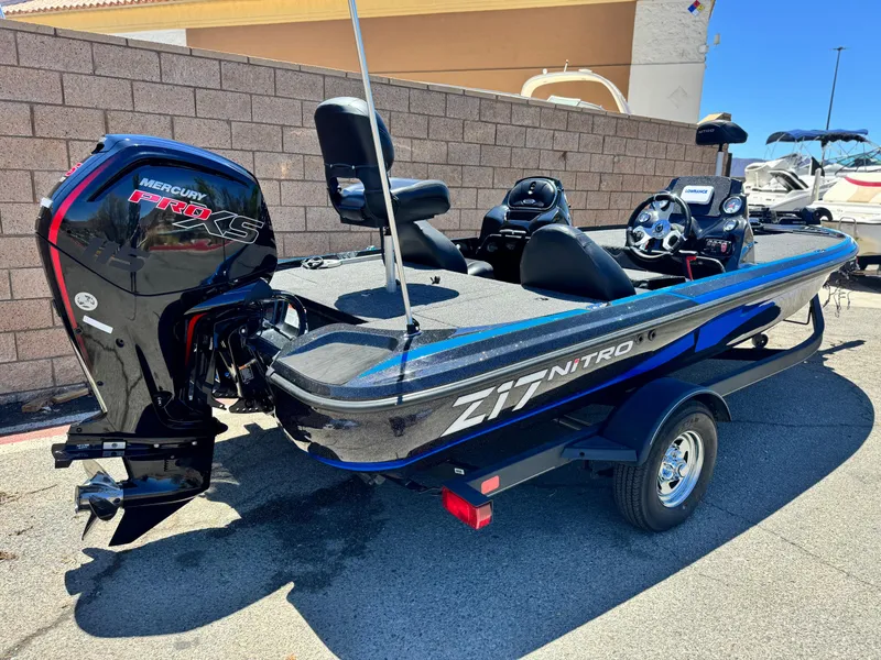 Slide: The Image of 2024 Tracker Z17 boat with Mercury Pro XS engine, parked outdoors. - 5
