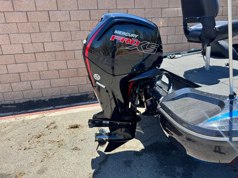 Slide: The Image of 2024 Tracker Z17 boat with Mercury Pro XS outboard motor, parked on pavement. - 6