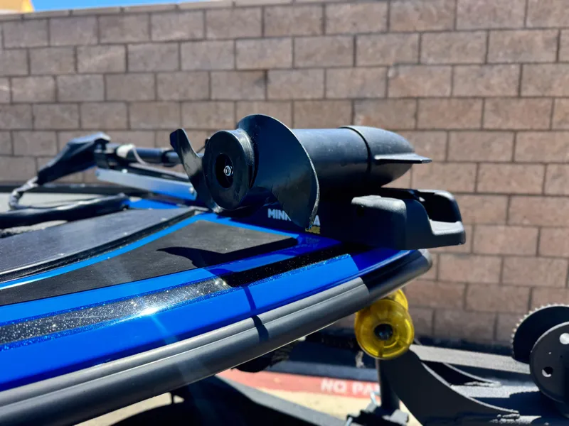 Slide: The Image of 2024 Tracker Z17 boat detail with mounted equipment, against a brick wall background. - 7