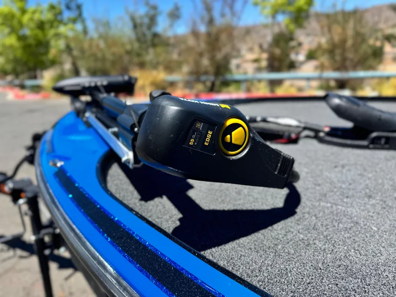 Slide: The Image of 2024 Tracker Z17 boat with trolling motor on blue deck, outdoors. - 8