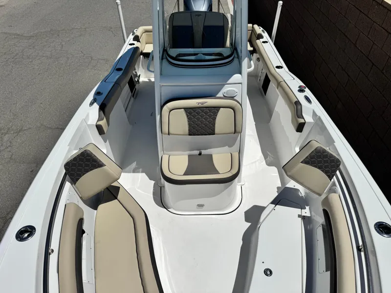 Slide: The Image of 2022 Tidewater 232 CC boat interior with beige and black seating, center console, and spacious layout. - 11