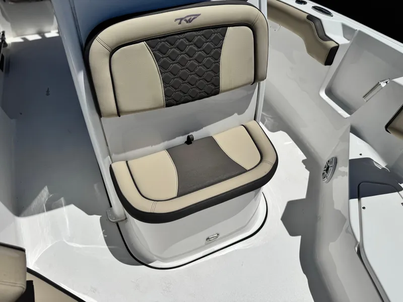 Slide: The Image of 2022 Tidewater 232 CC boat seat with beige and black upholstery, featuring a stylish design. - 12