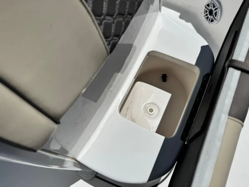 Slide: The Image of 2022 Tidewater 232 CC boat interior storage compartment with speaker detail. - 13