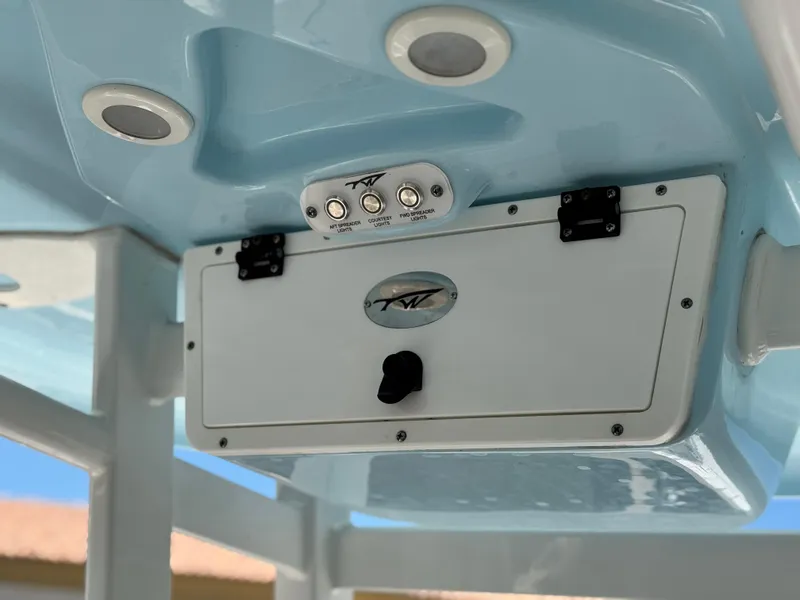Slide: The Image of 2022 Tidewater 232 CC boat console with control panel and storage compartment. - 16