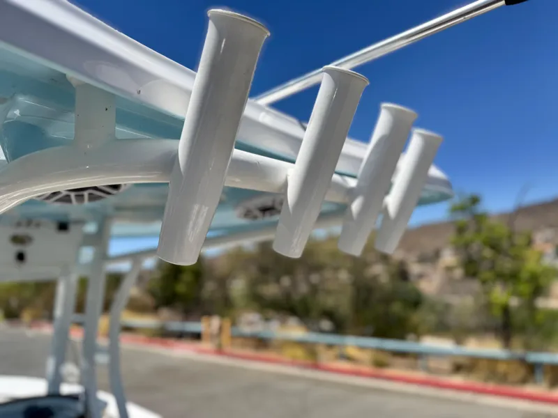 Slide: The Image of Close-up of rod holders on a 2022 Tidewater 232 CC boat under a clear blue sky. - 17