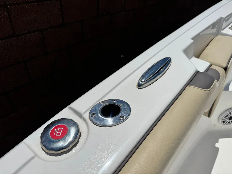 Slide: The Image of 2022 Tidewater 232 CC boat detail with fuel cap and rod holder. - 20