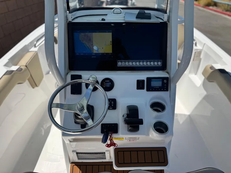 Slide: The Image of 2022 Tidewater 232 CC boat console with steering wheel and navigation display. - 25