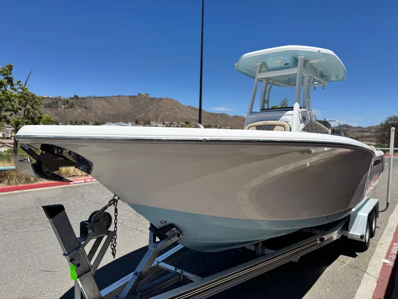 Slide: The Image of 2022 Tidewater 232 CC boat on trailer under clear blue sky. - 3